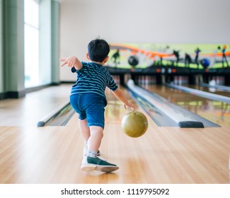  Back View Child Throwing Rolling Bowling Ball