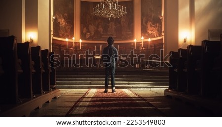 Back View: Christian Man Standing in front of the Altar and Starting to Pray in a Church. He Seeks Guidance From his Religious Faith and Spirituality. Spirit of Christianity and Belief in God