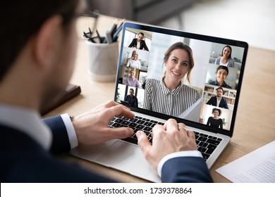 Back View Close Up Of Male Employee Speak Talk On Video Call With Diverse Colleagues On Laptop, Businessman Engaged In Webcam Conference On Computer, Have Web Distant Online Meeting With Coworkers