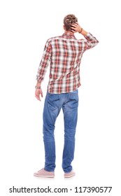 Back View Of A Confused Young Casual Man With His Hand On The Back Of His Head. Isolated On White