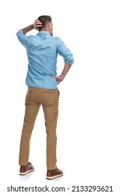 Back View Of Confused Young Man In Denim Shirt Scratching Head And Thinking Of Some Difficult Problems On White Background 