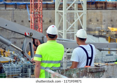 Back view of a construction workers walking into a building site