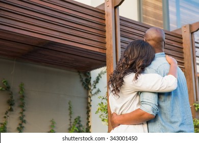 Back View Of Couple With Arms Above After Buying House