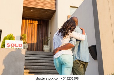 Back View Of Couple With Arms Above After Buying House