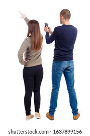 Back view of couple in sweater with mobile phone. beautiful friendly girl and guy together. Rear view people collection. backside view of person. Isolated over white background. - Shutterstock ID 1637899156