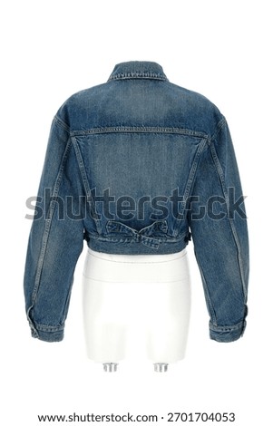 Back view of a cropped denim jacket with a classic collar and button detailing presented on a white mannequin against a white background