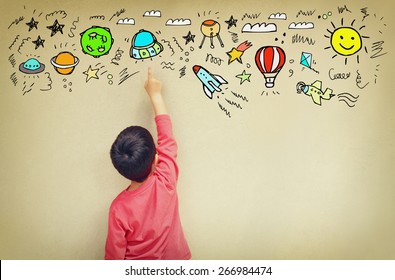 Back View Of Cute Kid Imagine Space Travel With Set Of Infographics Over Textured Wall Background