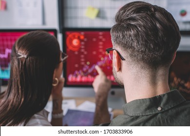 Back view of data analysts working on protection of computer systems in office