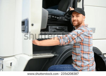 Back view of driver getting into truck cabin