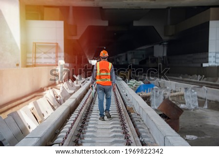 Back view engineer, worker walk on railway inspection. construction worker on railways. Engineer work on railway. rail, engineer, Infrastructure