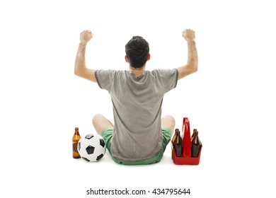 Back View Of A Excited Man With Soccer Ball And Pack Of Beer Looking At Wall. Rear View. Isolated On White Background