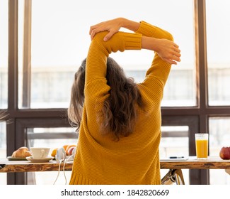 Back View Of Faceless Young Woman With Stiff Muscles, Tense And Joints Ache. Stretching Of Limbs, Warm-up, Exercise At Workplace, Pull-up