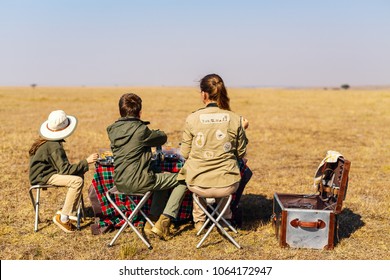 Back View Family Of Mother And Kids On African Safari Vacation Enjoying Bush Breakfast