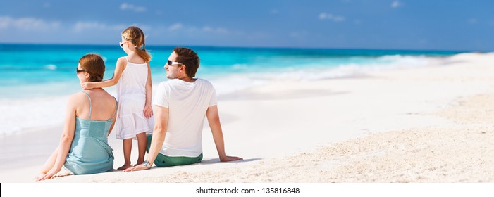 Back View Of A Family On A Tropical Beach