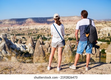 Back View Of Father And His Teenage Daughter Familly Enjoying View Over Gorkundere Valley With Rock Formations And Fairy Chimneys In Cappadocia Turkey