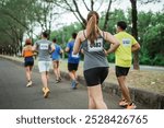 back view of female athlete participating at marathon competition