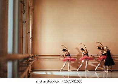 Back view of female ballet dancers having a class with ballet teacher at dance studio. Copy space.  - Powered by Shutterstock