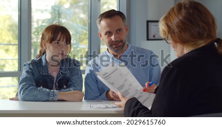 Back view of female headmaster interview father and preteen girl in school office. Smiling mature man with teenage daughter meeting woman principal ストックフォト © 