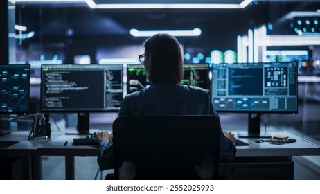 Back View of Female Telecommunications Manager Working in Research and Development Facility on a Desktop Computer in Modern Office. Focused Software Engineer Updating Server System Database