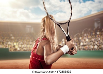 back view of a female tennis player with a racket in action