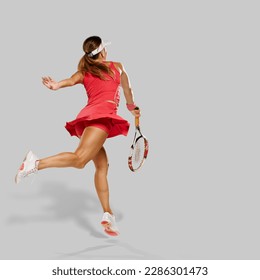 Back view of fit healthy girl having tennis training, She is in the middle of tennis practice and her body is tilted to the side in a jump as she prepares to hit the ball. - Powered by Shutterstock