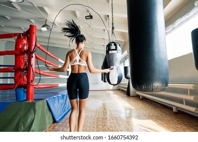 Back view of fitness woman skipping rope in gym. Cardio and fitness workout. Sport concept            - Powered by Shutterstock