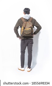 Back View Full Length Portrait Of Young Man In Sweatshirts With Jacket And Black Pants And Brown Backpack Standing On White Background