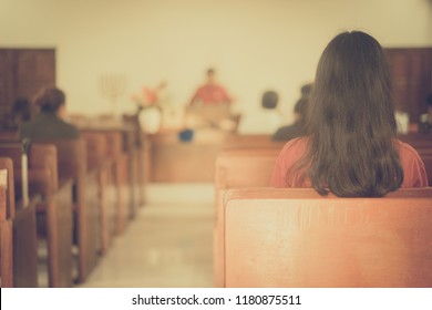 Back view of Girl in Church.Church Congregation Service and Christian worship.church interior background.vintage tone.