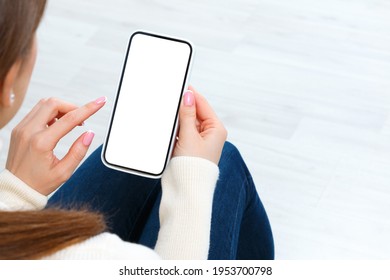 Back View Of Girl Holding Smartphone With White Blank Screen Mockup. Lifestyle Concept With Digital Technology.