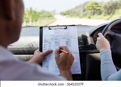 Back View Of Girl Taking Driving Test 