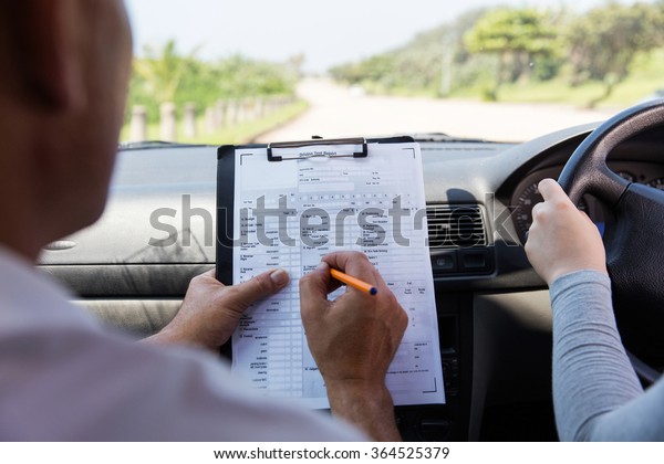 back view of girl\
taking driving test 