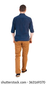 Back view of going  handsome man in jeans and a shirt.  walking young guy .  Isolated over white background.  man in brown pants, shirt sleeves rolled away into the distance.