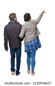 Back view of going interracial couple. walking friendly girl and guy holding hands. Rear view people collection. backside view of person. A couple in warm clothes on a stroll and sees sights