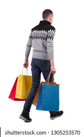 Back view of going man with shopping bags. guy in motion. backside view of person. Rear view people collection. Isolated over white. A young guy in a gray jacket carries purchases from the store.