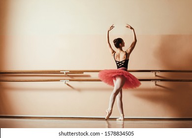 Back View Of Graceful Ballet Dancer Rehearsing At Ballet Studio. Copy Space. 