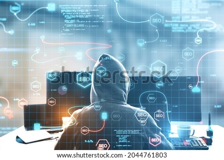 Back view of hacker at desktop using abstract interface with glowing SEO hologram and icons on blurry background. Search engine optimization, hacking and coding concept. Double exposure