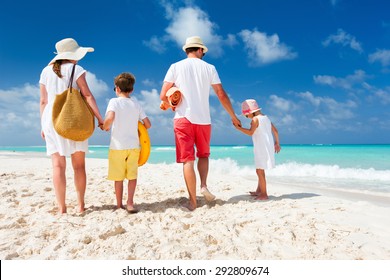 Back View Of A Happy Family With Kids On Tropical Beach Vacation