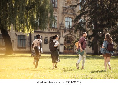 Back View Of Happy Multicultural Students Running To University