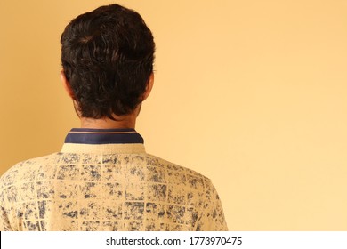 Back View Or Back Of Head Of A Young Asian Indian Man With Copy Space For Text Isolated On Yellow Background.