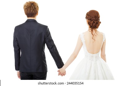 Back View Of Holding Hands Bride And Groom Isolated On White