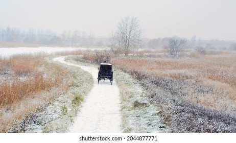 Back View Of Horse Carriage On Countryside Road In Winter