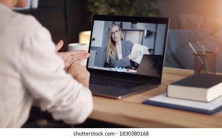 Back view of impersonalized person having distant communication with business partner through video call