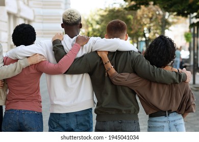 Back view of international group of people making strike on the street, hugging, showing their strong unity, demanding from government saving planet, reducing pollution. Riot, demonstration, strike - Powered by Shutterstock