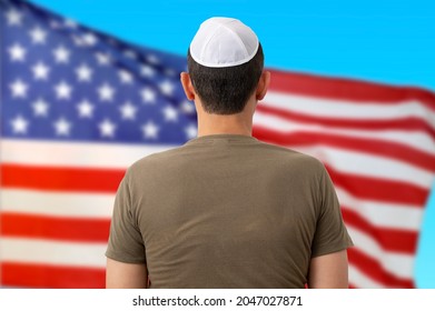 Back view of jewish citizen wearing yarmulke in front of american flag for multi-ethnicity nature of USA