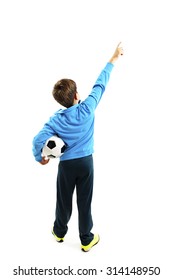 Back view of little boy holding football, points at wall. Rear view. Isolated on white background 

