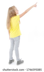 Back view of little girl points at wall. Rear view. Isolated on white background