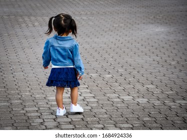 Back view of little girl walking - Powered by Shutterstock