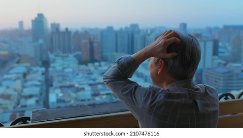 Back View Of Lonely Asian Old Man Looking Outside From Home