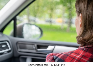 Back View Of Lonely Girl Looking Through Rainy Window With Drop Of Car. 