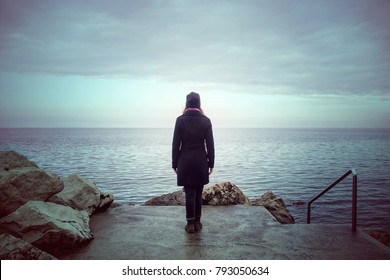 Back View Of Lonely Woman Looking The See, Loneliness Concept In Winter Season